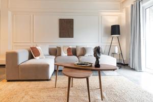 a living room with a couch and a table at Elegant 3 Bdr Apartment City Retreat in Kypseli in Mesochórion
