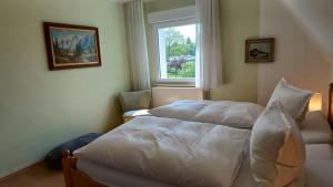 a bedroom with two beds and a window at Ferienhaus Birkelbach in Erndtebrück