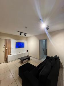 a living room with a couch and a tv on the ceiling at Depar R&L in Encarnación