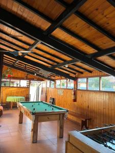 a large room with a pool table in it at Pousada dos Pássaros in Camanducaia