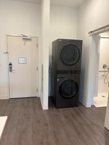 a washer and dryer in a room with a door at THE NEST in Greenfield