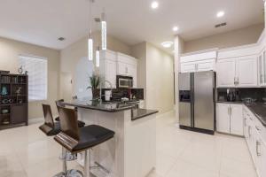 a kitchen with a counter and a refrigerator at Big Private Luxury Home in Beach Gated Community in South Padre Island