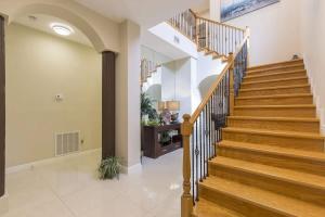 a hallway with wooden stairs in a home at Big Private Luxury Home in Beach Gated Community in South Padre Island