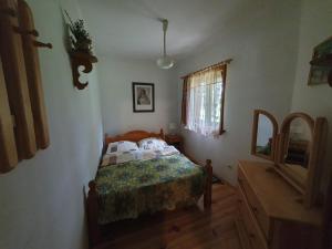 a bedroom with a bed and a mirror in it at Domki Bartoszówka 