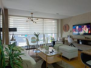 a living room with a couch and a table at Like a Home - 2Bedrooms - QueenBed - Balcony - Parking - 7Th FLOOR in Quito