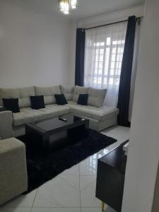 a living room with a couch and a coffee table at Del's Homes -Ruiru in Ruiru