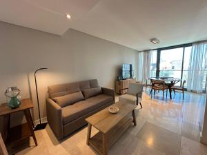 a living room with a couch and a table at Clara Suite in Mar del Plata