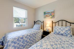 a bedroom with two beds and a window at Lovely Emerald Isle Home, Walk to Beach! in Emerald Isle