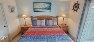 a bedroom with a bed with two lamps on tables at Max Walkable Location 1st Floor 2 Patios in South Padre Island