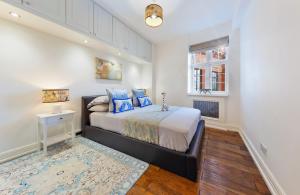 a bedroom with a large bed and a window at ROYAL Apartment in HARRODS in London
