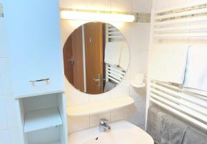 a bathroom with a sink and a mirror at Rückzugsort im Buhlbachtal Baiersbronn - Ferienwohnung mit beheiztem Wintergarten, Bergblick & Parkplatz in Baiersbronn +66 photos