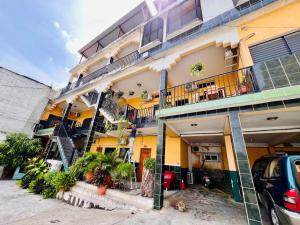 a large building with balconies and plants on it at Hotel Hernandez in Chiquimula