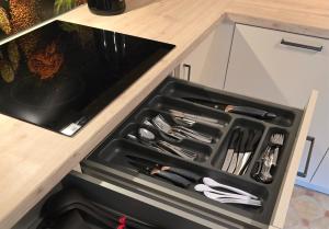 a black drawer with utensils in it in a kitchen at Rückzugsort im Buhlbachtal Baiersbronn - Ferienwohnung mit beheiztem Wintergarten, Bergblick & Parkplatz in Baiersbronn