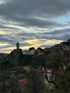 a view of a city with a lighthouse on a hill at Lydias house II in Arachova
