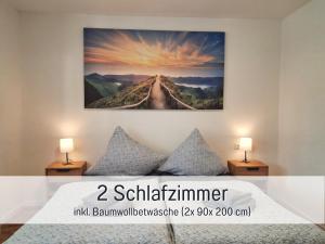 a painting hanging on a wall above a bed at Germersheimer Rhein-Quartier in Germersheim