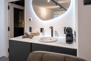a bathroom with a sink and a mirror at Cave-Salzburg in Salzburg
