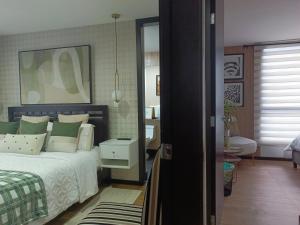 a bedroom with a bed and a mirror at Like a Home - 2Bedrooms - QueenBed - Balcony - Parking - 7Th FLOOR in Quito +44 photos