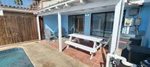 a patio with a picnic table and a pool at 3 bedr w-private pool 1 block to beach Pets Ok in South Padre Island