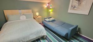 a bedroom with a large bed and a blue couch at 3 bedr w-private pool 1 block to beach Pets Ok in South Padre Island +32 photos