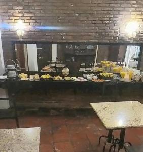 a kitchen with a buffet of food on a table at Hotel Diplomata in Tupanciretã