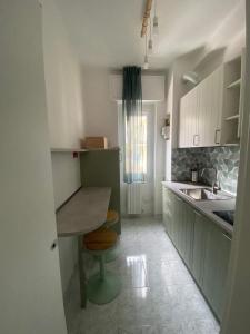 a small kitchen with a table and a sink at Pitia House in Rozzano