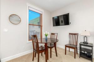a dining room with a table and chairs and a window at Stylish Grand Lake Retreat - King Bed - Walk to Lake in Grand Lake +12 photos