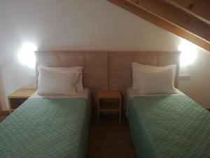 a bedroom with two beds and two night stands at Vila Lira in Aljezur
