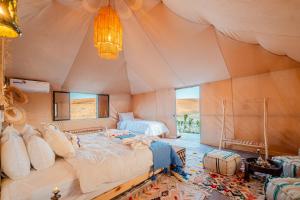 a bedroom with two beds in a tent at we agafay in El Karia