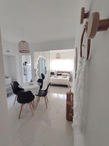 a white living room with a table and chairs at Tengotudeptomdq in Mar del Plata