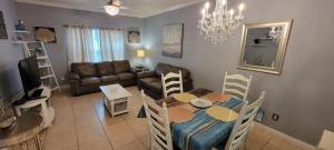 a living room with a table and a couch at EZ Walk to Beach Modern 2 bedroom Sleeps Many in South Padre Island