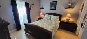a bedroom with a bed and a chair and lamps at EZ Walk to Beach Modern 2 bedroom Sleeps Many in South Padre Island