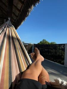 a man laying in a hammock with his feet up at chale vilana in Atins