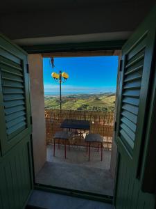 a view of a table and chairs from a window at Ca' Sole in Butera