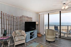 a living room with a television and a balcony at Sea Colony - 709 Brandywine House Rd in Bethany Beach +39 photos