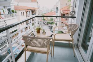 a balcony with two chairs and a table on a balcony at Downtown Hideaway in Thessaloniki