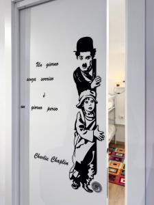 a drawing of a man and a child on a wall at Ca' Sole in Butera