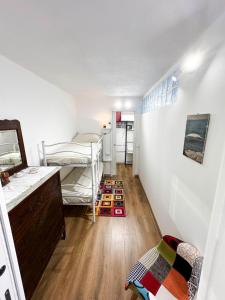 a room with two bunk beds and a wooden floor at Ca' Sole in Butera