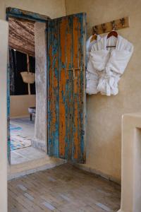 an open door in a room with towels at Berber Beldi Camp in Imsouane