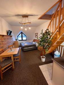 a living room with a couch and a table at Penzion Mona Rooms & Apartments in Harrachov