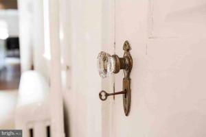 an open door with a rusty door knob at THE ADDAMS HOUSE - LANCASTER HISTORIC DISTRICT in Lancaster +9 photos
