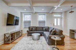 a living room with a couch and a flat screen tv at THE HAMILTON HOUSE - DOWNTOWN COLONIAL LANCASTER in Lancaster +45 photos