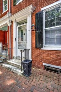 a trash can sitting outside of a brick house at THE HAMILTON HOUSE - DOWNTOWN COLONIAL LANCASTER in Lancaster