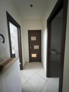 a hallway with a door and a tiled floor at Dreaming About Italy in Torre Annunziata