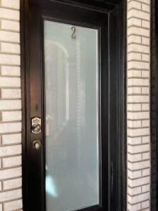 a black door with a glass window on a brick building at THE STEVENS STUDIO - HISTORIC DOWNTOWN LANCASTER in Lancaster