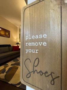a sign that says please remove your shoes at THE STEVENS STUDIO - HISTORIC DOWNTOWN LANCASTER in Lancaster