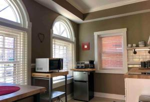 a kitchen with two arched windows and a microwave at THE STEVENS STUDIO - HISTORIC DOWNTOWN LANCASTER in Lancaster +50 photos