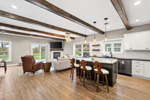 a kitchen and living room with a bar and chairs at Village Townhouse Walk to Shops Garage in Ellicottville