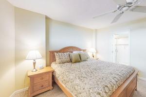 een slaapkamer met een bed en een tafel met een lamp bij Sea Colony - 1005N Edgewater House Rd in Sea Colony +41 foto's