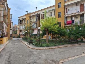 an empty street with benches in front of buildings at B&B Dolce Riposo in Foggia