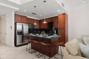 a kitchen with a island in the middle of a room at Prestigious Luxury Beach & Bay Patios XL Size in South Padre Island +25 photos